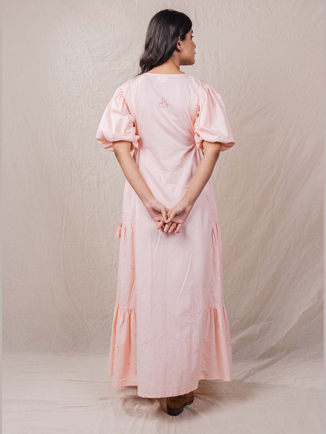 a line rose pink colour dress in pure cotton. with tiers and gathers on the side. hand embroidered V neckline with other fine handwork details at the back of the dress.
