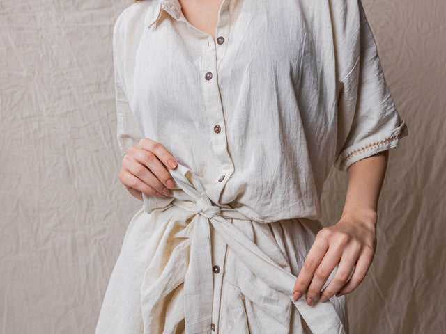 drawstring button down dress jacket in beige handwoven fabric. with collars and hand embroidery and handwork details.