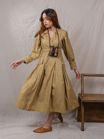 trench dress, cinched around waist, with pockets, puff sleeves with power shoulders, overlap front, detail of buttons on sleeves with embroidery