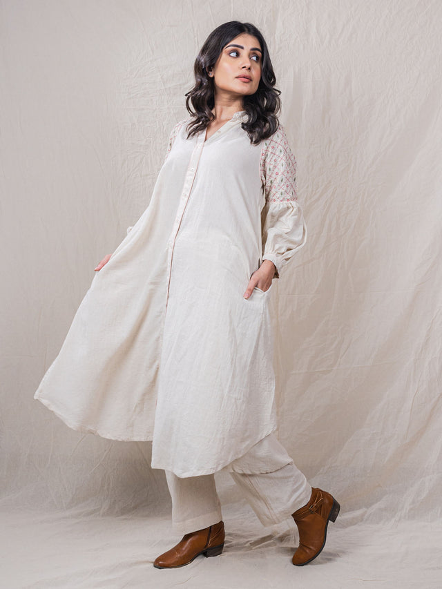 two piece set of tunic and pants with contrast piping, hand embroidery of criss cross with safari essence on shoulder and sleeves, button down, beads on sleeve hem, straight bottom pants, flamingo motif at back