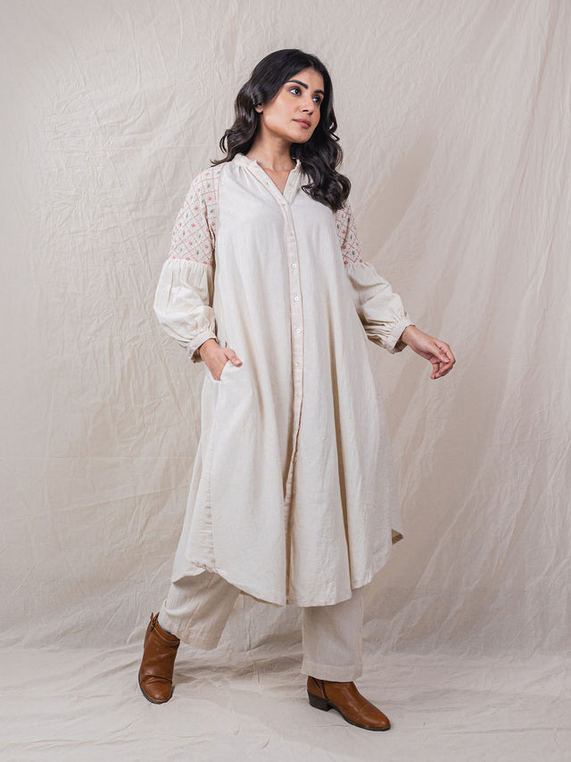 two piece set of tunic and pants with contrast piping, hand embroidery of criss cross with safari essence on shoulder and sleeves, button down, beads on sleeve hem, straight bottom pants, flamingo motif at back